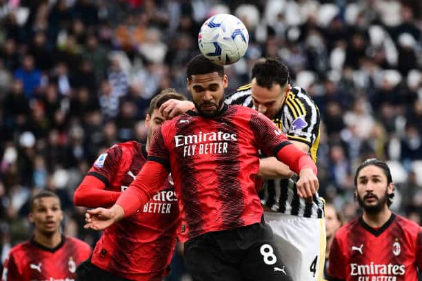 AC Milan's English midfielder #08 Ruben Loftus-Cheek heads the ball next to Juventus' Italian defender #04 Federico Gatti (R) during the Italian Serie A football match between Juventus and AC Milan at The Allianz Stadium in Turin on April 27, 2024. (Photo by MARCO BERTORELLO / AFP) (Photo by MARCO BERTORELLO/AFP via Getty Images)